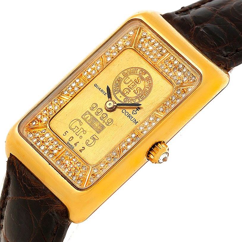 This image shows the Corum 42456 Women's Yellow Gold Champagne Dial 42456 Women's Yellow Gold Champagne Dial 18K Yellow Gold Diamond 5 Gram Ingot 999.9 Watch from a tilted angle, displaying the face, diamonds, and part of the strap.
