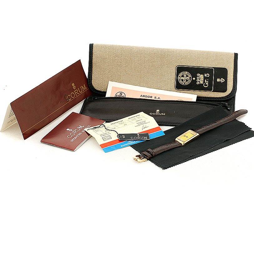 The image shows a Corum 42456 Women's Yellow Gold Champagne Dial 42456 Women's Yellow Gold Champagne Dial 18K Yellow Gold Diamond 5 Gram Ingot 999.9 Watch, with accompanying documentation and a watch case.