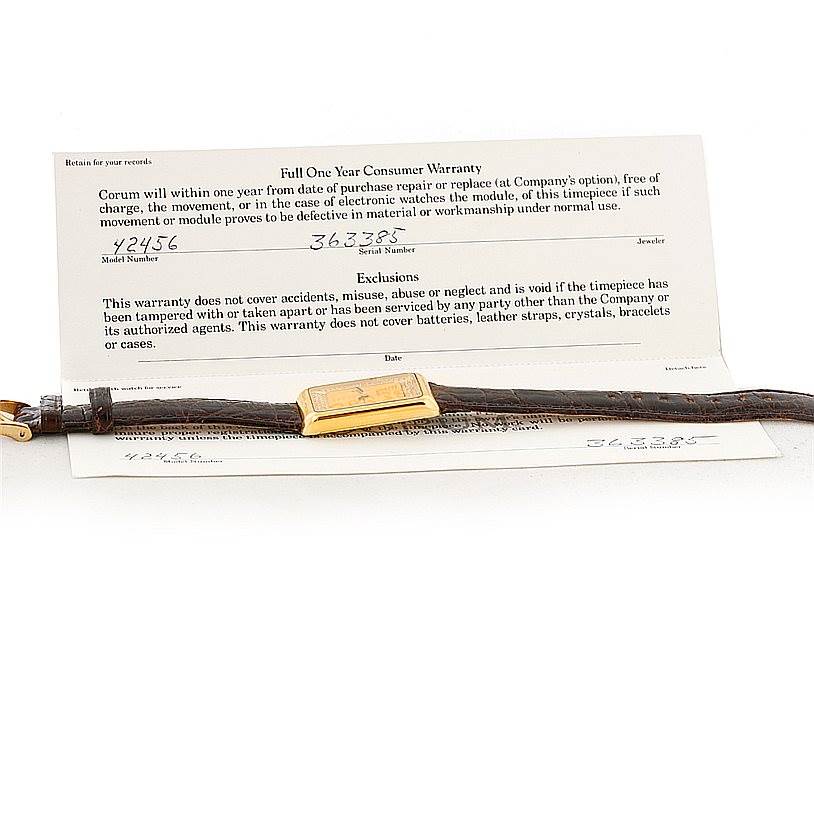 The image shows a Corum 42456 Women's Yellow Gold Champagne Dial 42456 Women's Yellow Gold Champagne Dial 18K Yellow Gold Diamond 5 Gram Ingot 999.9 Watch laid flat with its warranty card in the background.