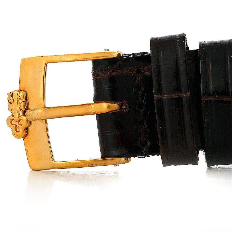 The image shows the buckle and part of the strap of the Corum Women's Yellow Gold Black Dial Women's Yellow Gold Black Dial Ladies 18K Yellow Gold 10 Dollars Coin Watch.