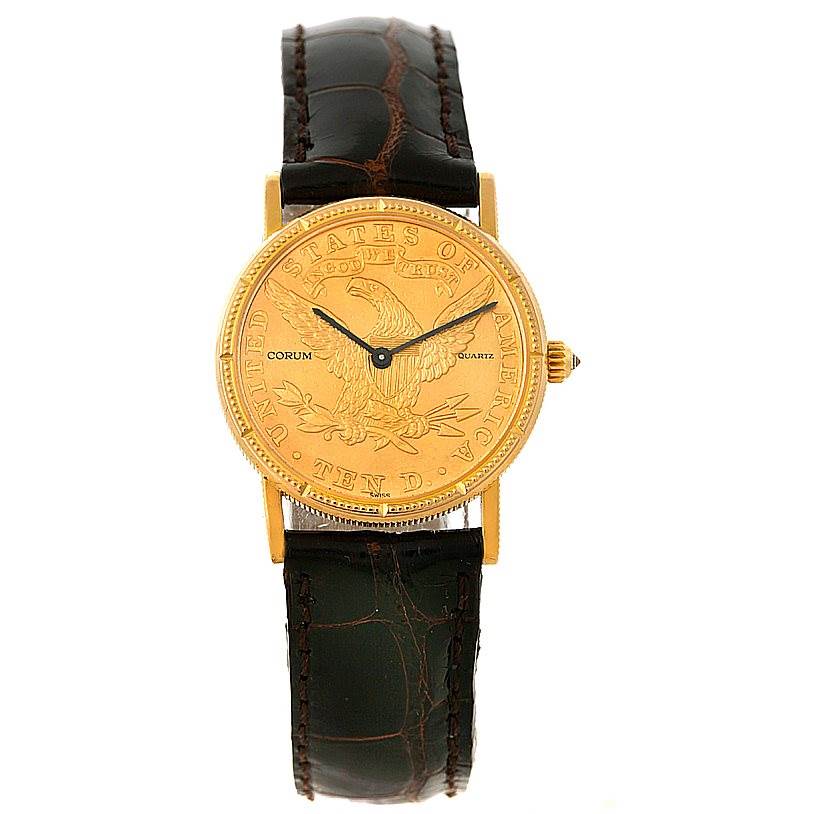 The image shows a frontal view of the Corum Women's Yellow Gold Black Dial Women's Yellow Gold Black Dial Ladies 18K Yellow Gold 10 Dollars Coin Watch, highlighting its dial and leather strap.