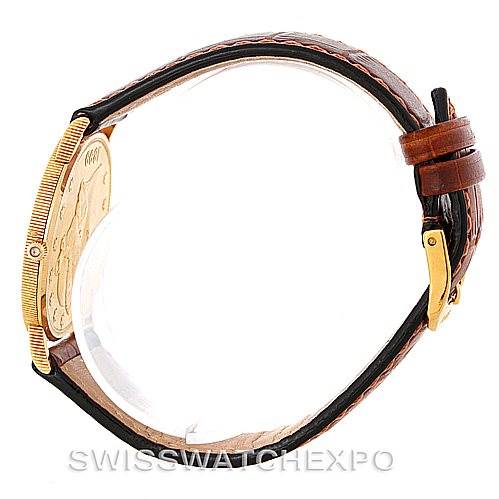 This image shows a Corum Coin Watch Men's Yellow Gold Black Dial Men's Yellow Gold Black Dial model from a side angle, displaying the watch case, bezel, and leather strap with buckle.