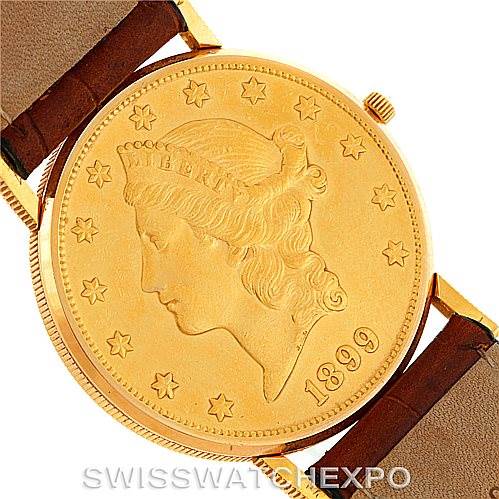 The image shows a Corum Coin Watch Men's Yellow Gold Black Dial Men's Yellow Gold Black Dial model from a top-down angle, featuring the dial and part of the leather strap.