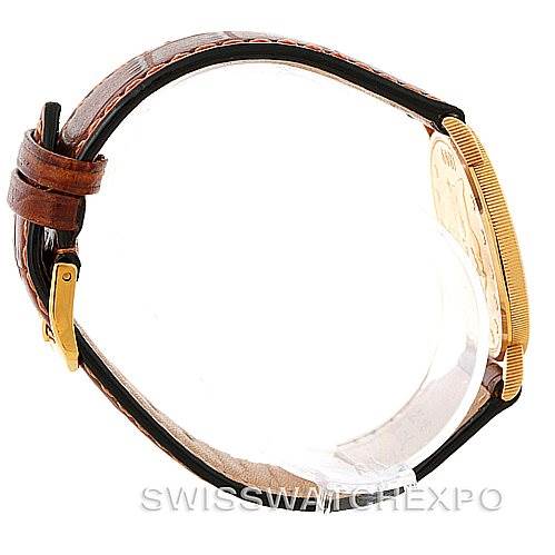 This image shows a side view of the Corum Coin Watch Men's Yellow Gold Black Dial Men's Yellow Gold Black Dial, highlighting the case, the coin dial, and the brown leather strap.