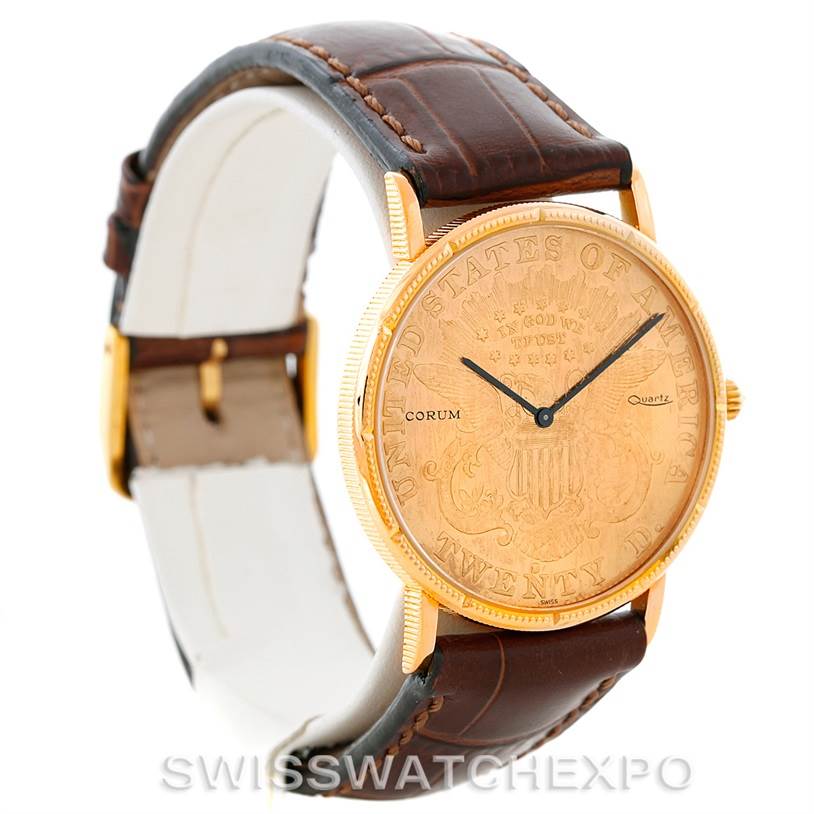 The image shows a Corum Coin Watch Men's Yellow Gold Black Dial Men's Yellow Gold Black Dial model at a three-quarter angle, highlighting its unique coin face and brown leather strap.