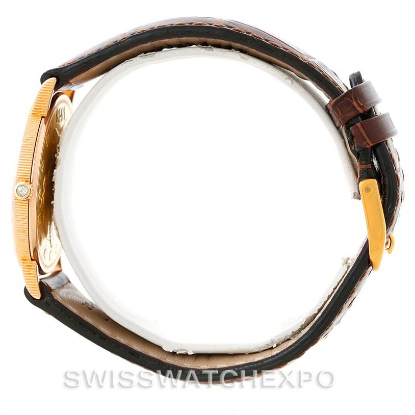 The image shows a side view of the Corum Coin Watch Men's Yellow Gold Black Dial Men's Yellow Gold Black Dial, highlighting the case, crown, and leather strap.