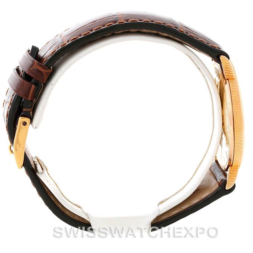 The Corum Coin Watch Men's Yellow Gold Black Dial Men's Yellow Gold Black Dial Model is shown from a side angle, highlighting the strap and profile of the watch case.