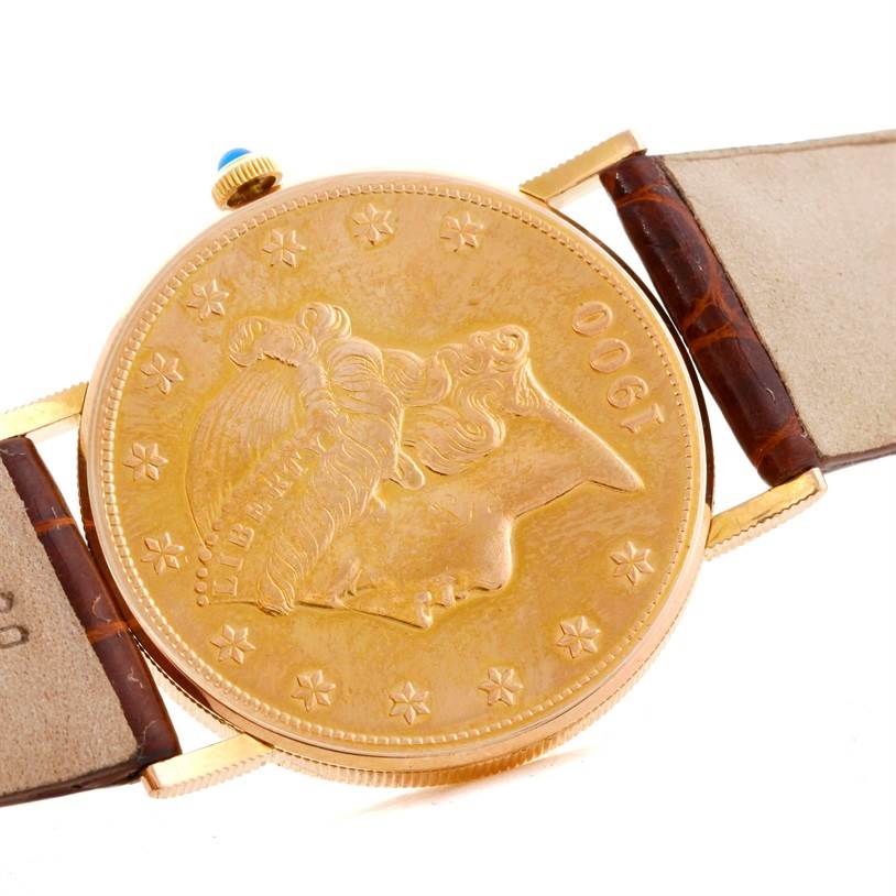 The image shows a close-up of the face, bezel, and strap ends of a Corum Coin Watch Men's Yellow Gold Black Dial Men's Yellow Gold Black Dial model.