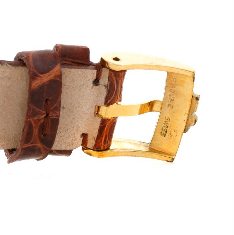 This image shows a close-up of the brown leather strap and gold buckle of the Corum Coin Watch Men's Yellow Gold Black Dial Men's Yellow Gold Black Dial model.