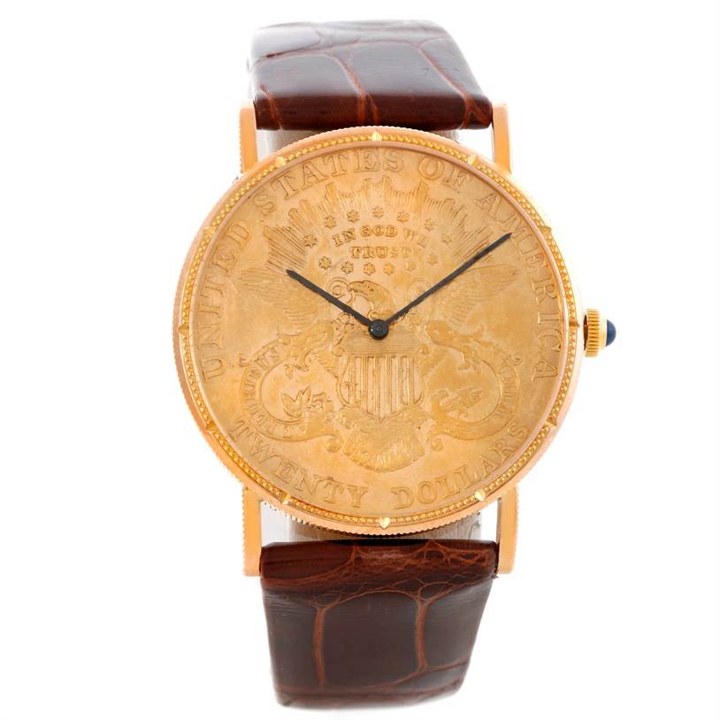 The image shows a front view of the Corum Coin Watch Men's Yellow Gold Black Dial Men's Yellow Gold Black Dial model, including the dial and leather strap.