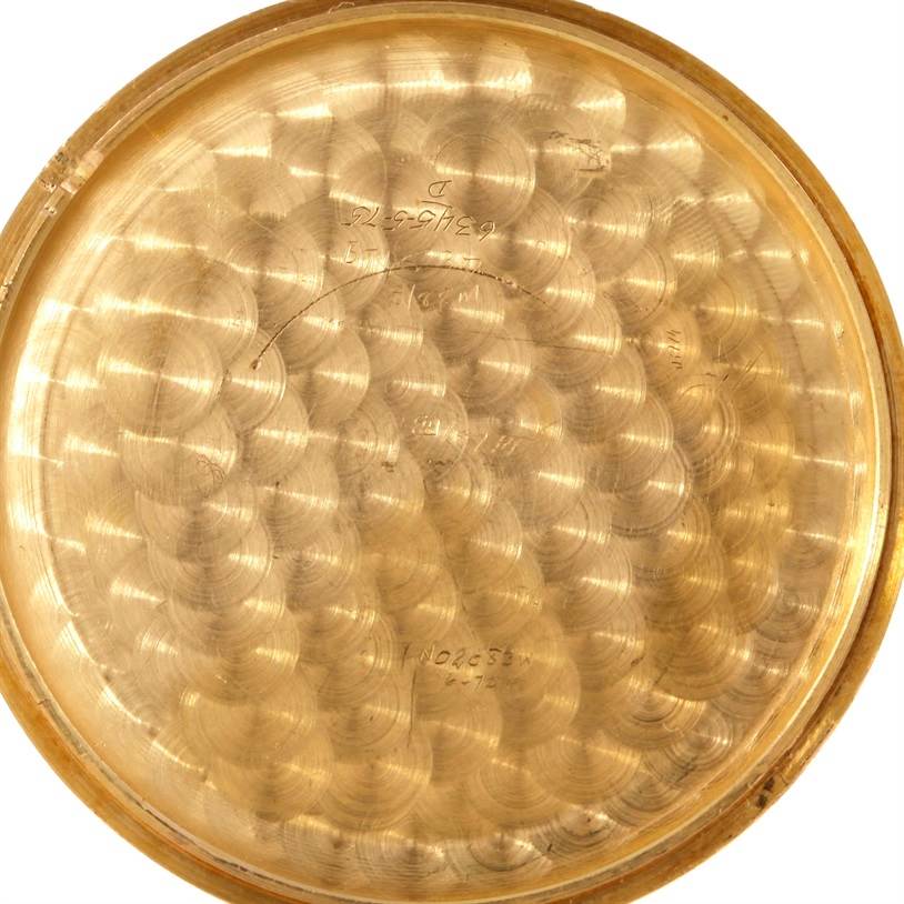 The image shows the inner side of the case back of a Corum Coin Watch Men's Yellow Gold Black Dial Men's Yellow Gold Black Dial, featuring intricate detailing and engravings.