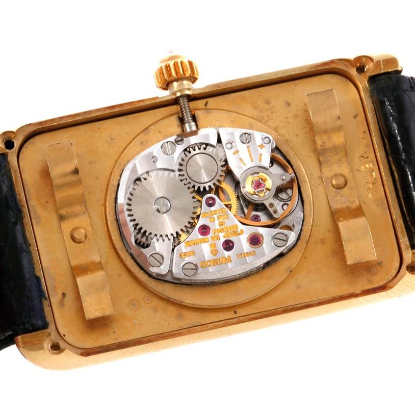 This image shows the back view of the Corum Women's Yellow Gold Champagne Dial Women's Yellow Gold Champagne Dial 18K Yellow Gold 10 Gram Ingot 999.9 Mechanical Ladies Watch, highlighting the intricate mechanical movement.