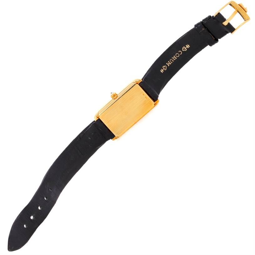 The image shows the back view of the Corum Women's Yellow Gold Champagne Dial Women's Yellow Gold Champagne Dial 18K Yellow Gold 10 Gram Ingot 999.9 Mechanical Ladies Watch with its black strap visible.