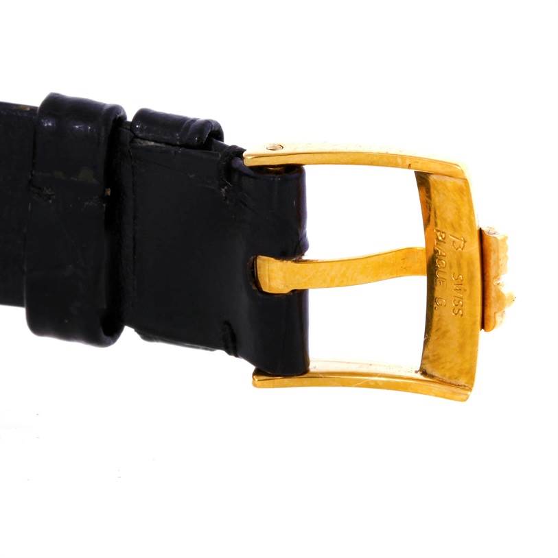 This image shows the gold buckle and part of the black leather strap of the Corum Women's Yellow Gold Champagne Dial Women's Yellow Gold Champagne Dial 18K Yellow Gold 10 Gram Ingot 999.9 Mechanical Ladies Watch.