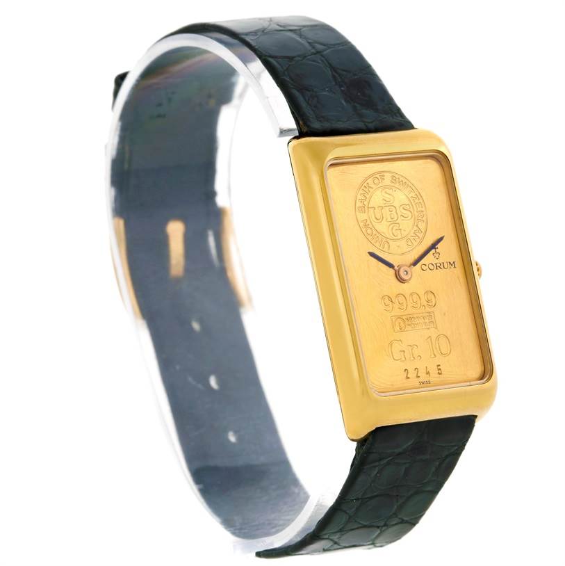 The image shows a side view of the Corum Women's Yellow Gold Champagne Dial Women's Yellow Gold Champagne Dial 18K Yellow Gold 10 Gram Ingot 999.9 Mechanical Ladies Watch with a black strap.