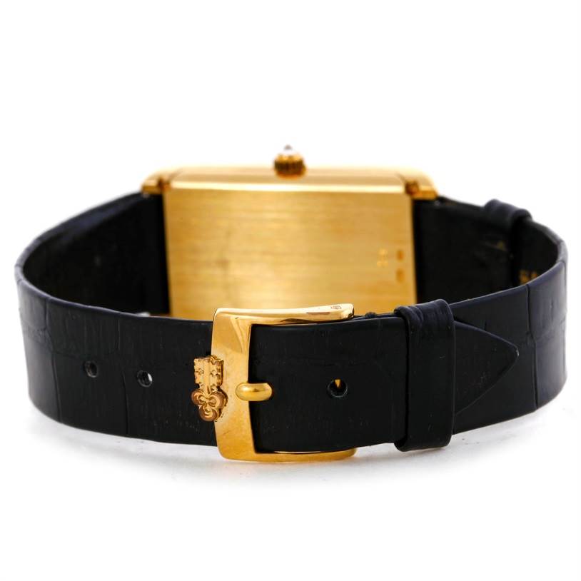 The image shows the Corum Women's Yellow Gold Champagne Dial Women's Yellow Gold Champagne Dial 18K Yellow Gold 10 Gram Ingot 999.9 Mechanical Ladies Watch from a rear angle, focusing on the buckle and strap.