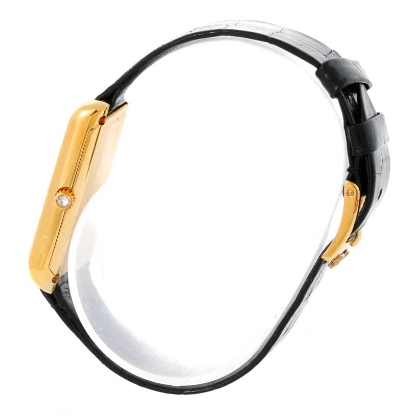 This image shows a side view of the Corum Women's Yellow Gold Champagne Dial Women's Yellow Gold Champagne Dial 18K Yellow Gold 10 Gram Ingot 999.9 Mechanical Ladies Watch, highlighting the watch's case and strap.