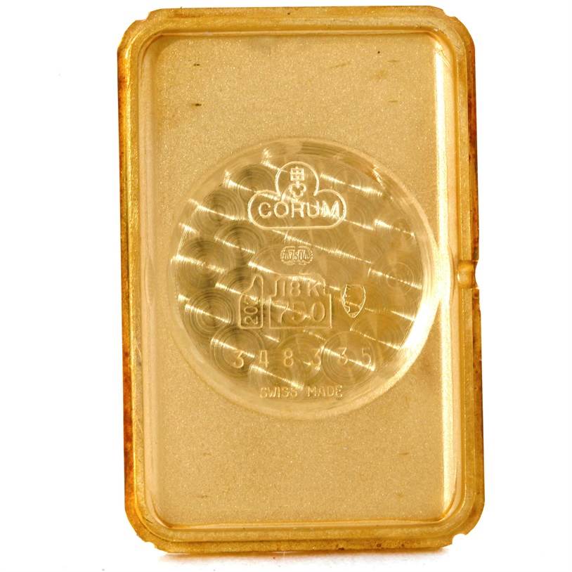 The image shows the back side of the Corum Women's Yellow Gold Champagne Dial Women's Yellow Gold Champagne Dial 18K Yellow Gold 10 Gram Ingot 999.9 Mechanical Ladies Watch, highlighting its engravings.