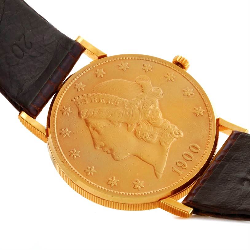 The image shows a close-up of the face and leather strap of the Corum Coin Watch Men's Yellow Gold Black Dial Men's Yellow Gold Black Dial model.