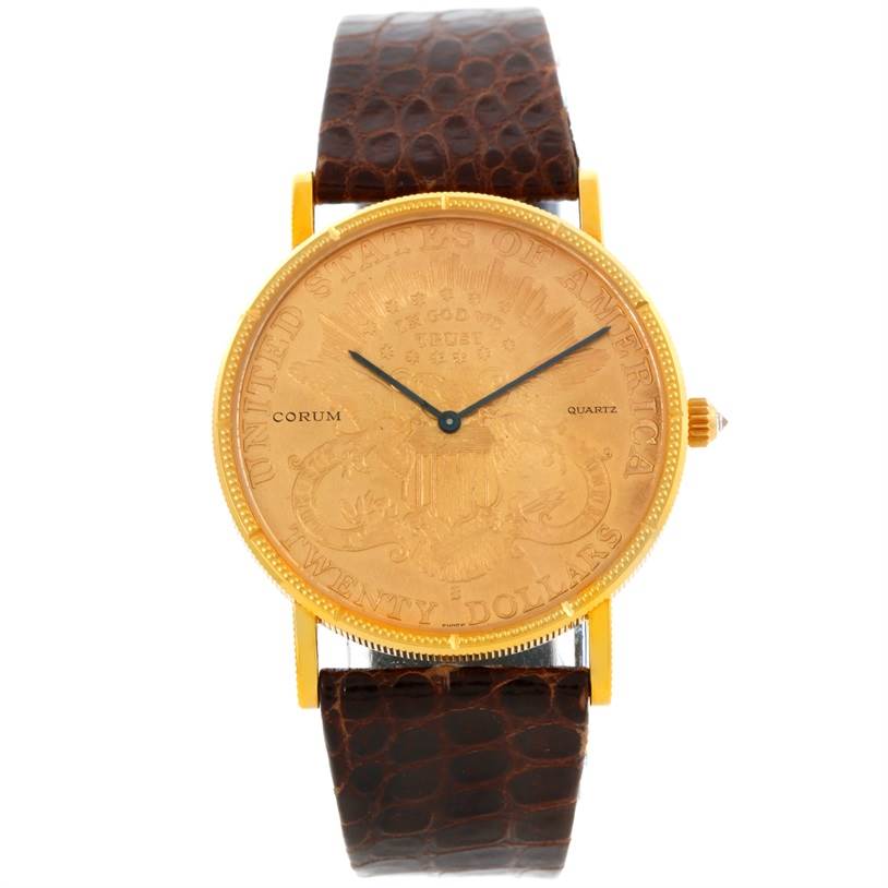 The Corum Coin Watch Men's Yellow Gold Black Dial Men's Yellow Gold Black Dial model is shown from a top-down angle, featuring the watch face and brown leather strap.