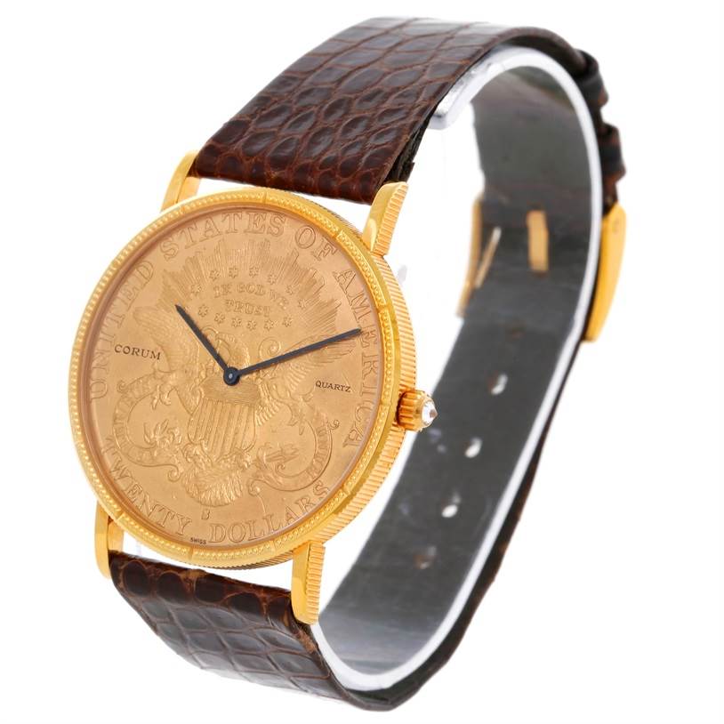 The image shows a Corum Coin Watch Men's Yellow Gold Black Dial Men's Yellow Gold Black Dial model from an angled view, displaying the watch face, brown leather strap, and gold detailing.