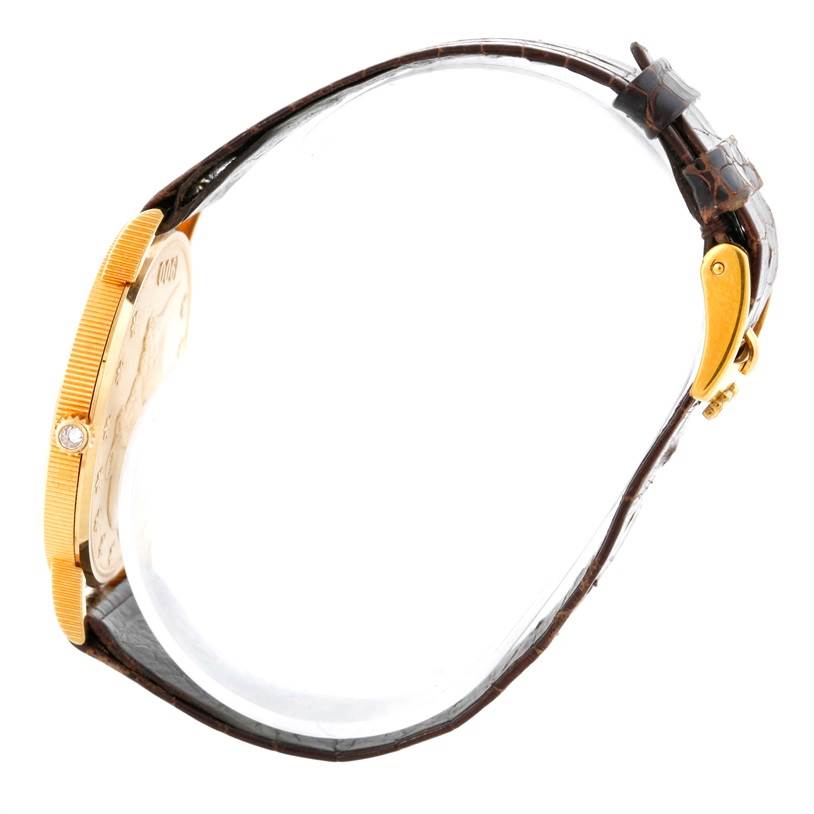 The image shows a side view of the Corum Coin Watch Men's Yellow Gold Black Dial Men's Yellow Gold Black Dial model, highlighting the case thickness, strap, and buckle mechanism.