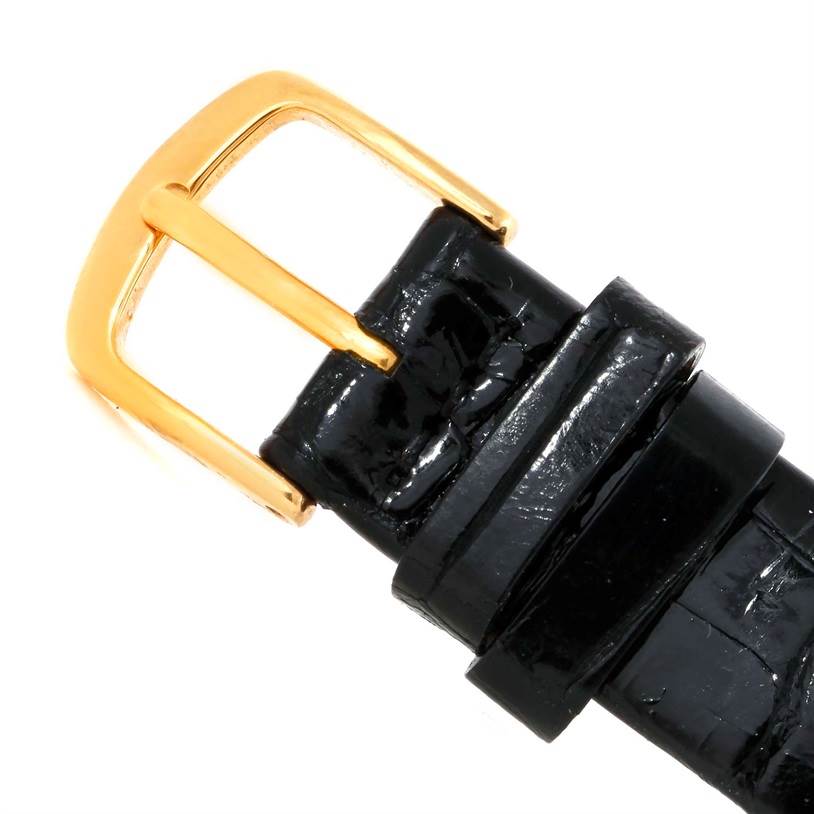 The image shows a close-up view of a Corum Coin Watch Men's Yellow Gold Black Dial Men's Yellow Gold Black Dial model buckle and black leather strap.