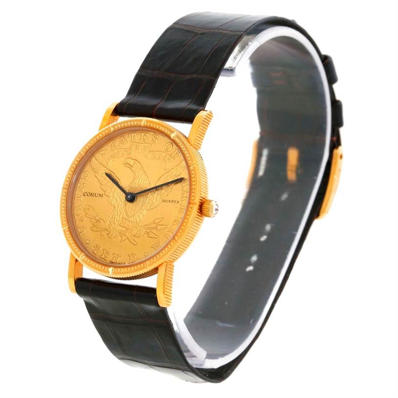 The Corum Women's  Women's  18K Yellow Gold 10 Dollars Coin Diamond Ladies Watch is shown from a slight side angle, displaying the dial, case, and black strap.