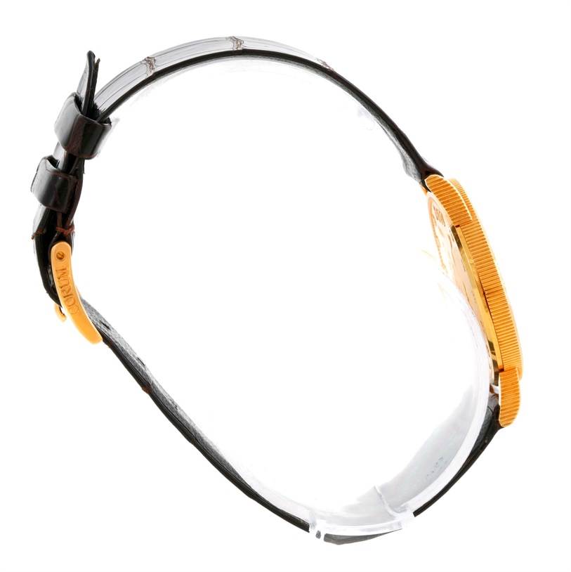 The image shows a side view of the Corum Women's  Women's  18K Yellow Gold 10 Dollars Coin Diamond Ladies Watch Unworn, displaying the watch band and case.