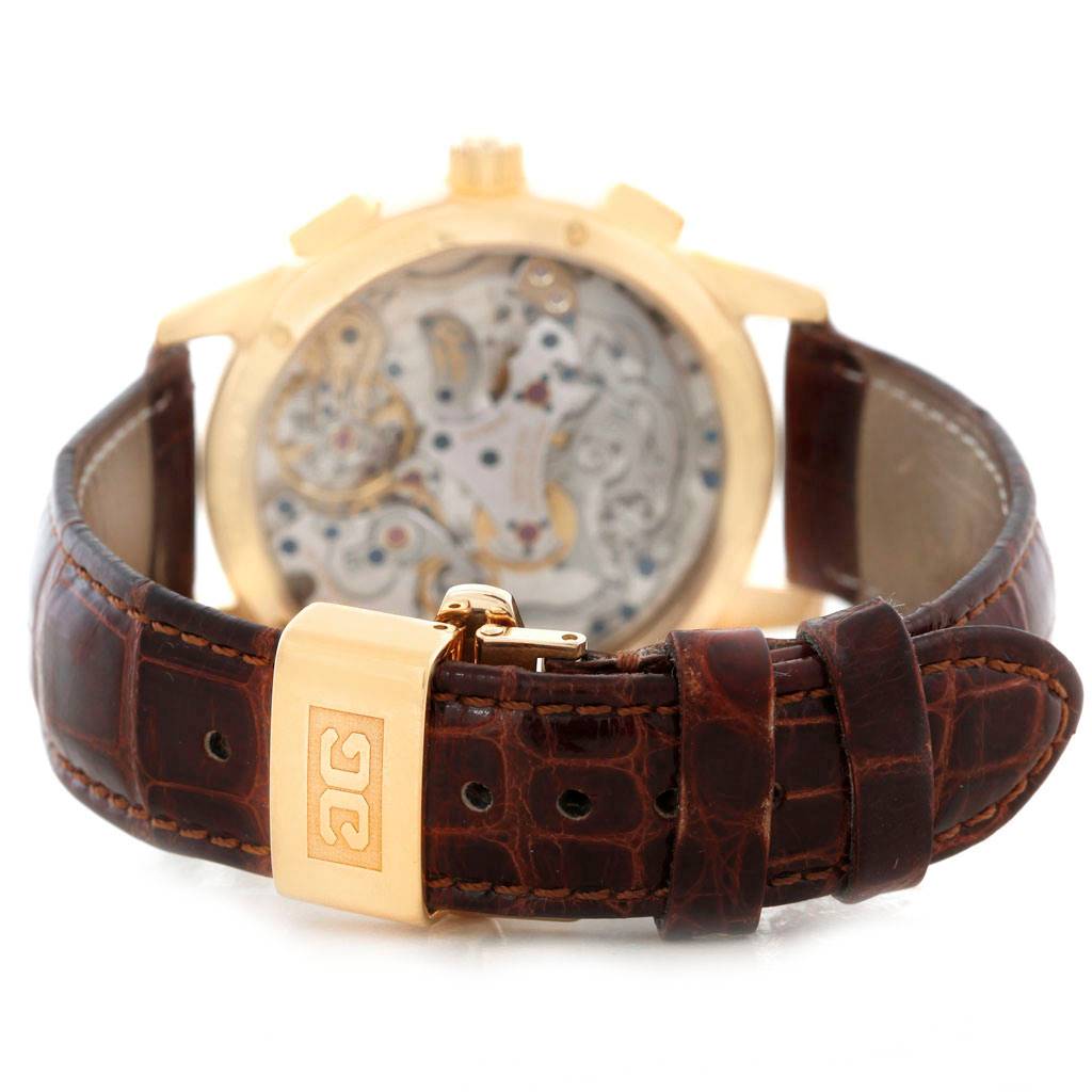 The image shows the back view of a Glashütte Pano model watch, highlighting the movement and leather strap with a gold clasp.