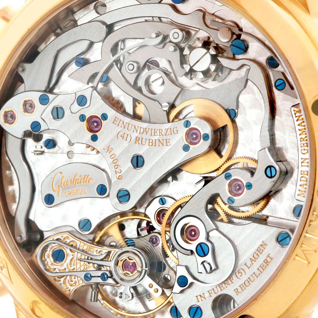 The image shows the intricate mechanical movement of a Glashütte Pano model watch viewed from the back.