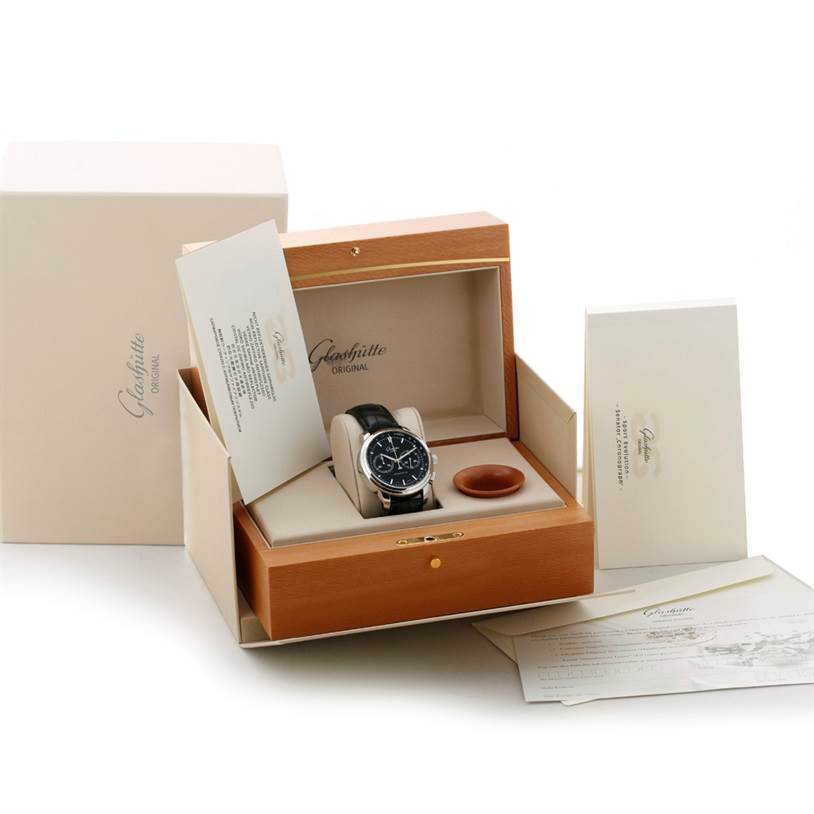 The image shows a Glashutte Original Senator model watch at a front angle, displayed in a wooden box with accompanying documentation.