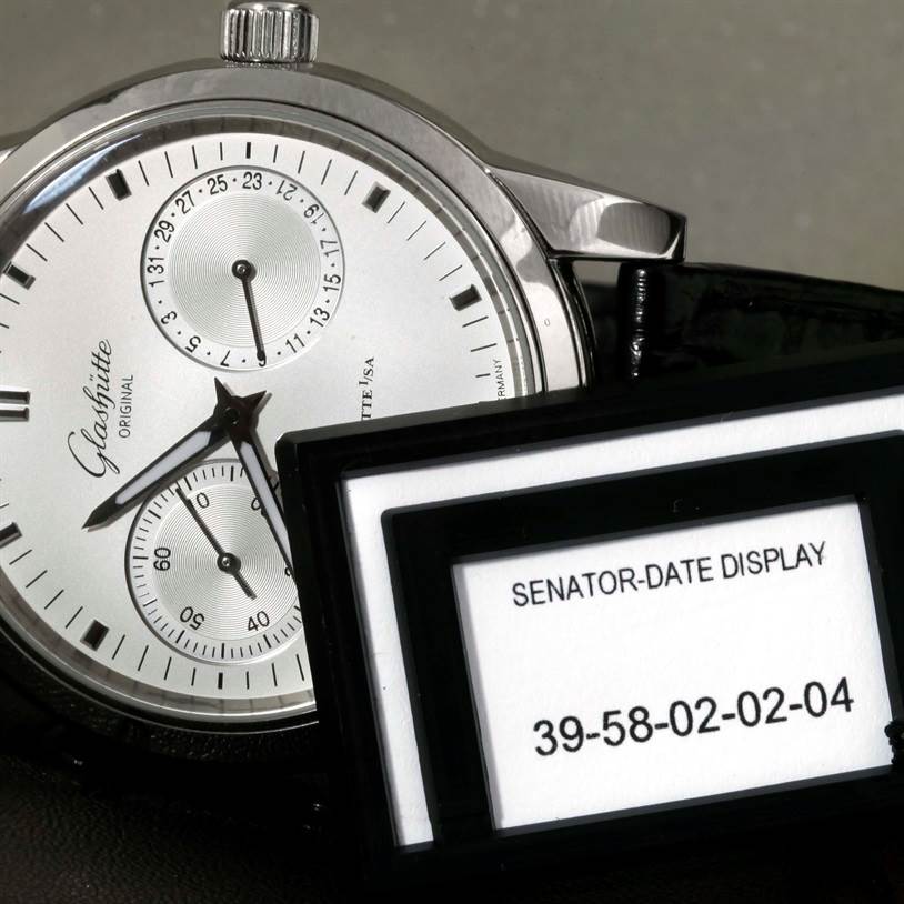 The Glashütte Senator watch is shown from a partial angled view, highlighting its face and a separate display indicating model specifics.