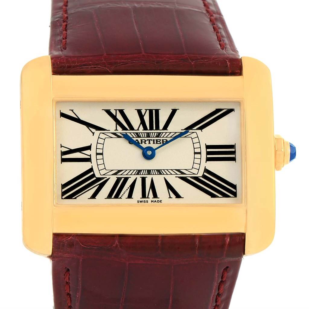 The image shows a Cartier Tank Divan W6300556? Yellow Gold Silver Dial W6300556? Yellow Gold Silver Dial watch from a front angle, highlighting its gold rectangular case, white dial, blue hands, and red leather strap.