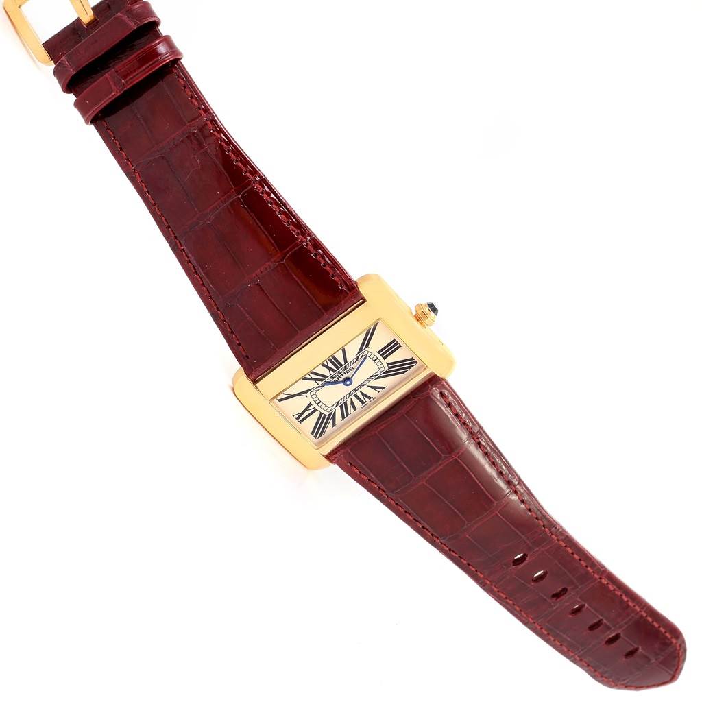 The Cartier Tank Divan W6300556? Yellow Gold Silver Dial W6300556? Yellow Gold Silver Dial watch is shown from a top-down angle, displaying its face, case, and leather strap.