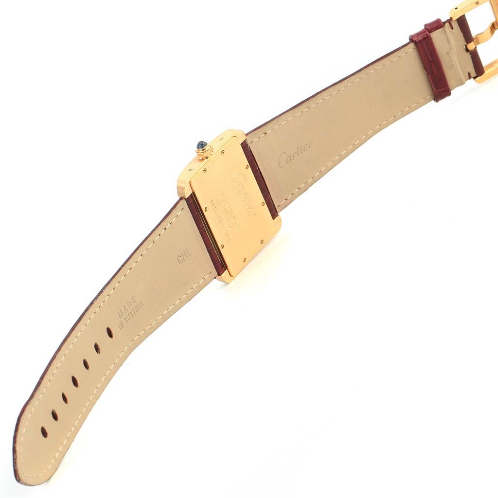 The image shows the back and strap of a Cartier Tank Divan W6300556? Yellow Gold Silver Dial W6300556? Yellow Gold Silver Dial watch, focusing on its leather strap and caseback.