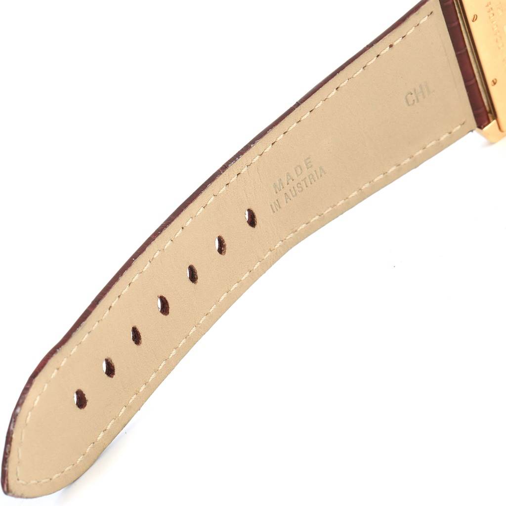 This image shows a close-up of the leather strap of a Cartier Tank Divan W6300556? Yellow Gold Silver Dial W6300556? Yellow Gold Silver Dial watch.
