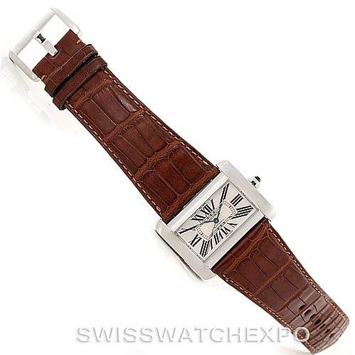 The Cartier Tank Divan W6300755 Men's Stainless Steel Silver Dial W6300755 Men's Stainless Steel Silver Dial watch is shown from a top-down angle, displaying its brown leather strap and rectangular face with Roman numerals.