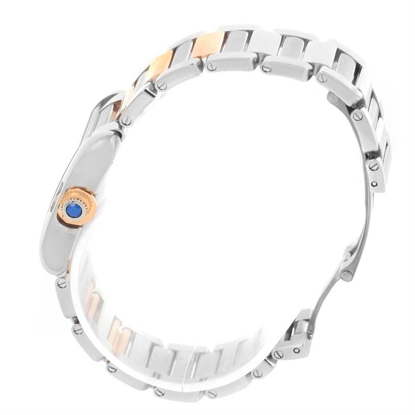 This image shows a Cartier Tank Anglaise WT100024 Women's Steel and Gold (two tone) Silver Dial WT100024 Women's Steel and Gold (two tone) Silver Dial watch viewed from the side, highlighting the metal links and crown with a blue cabochon.