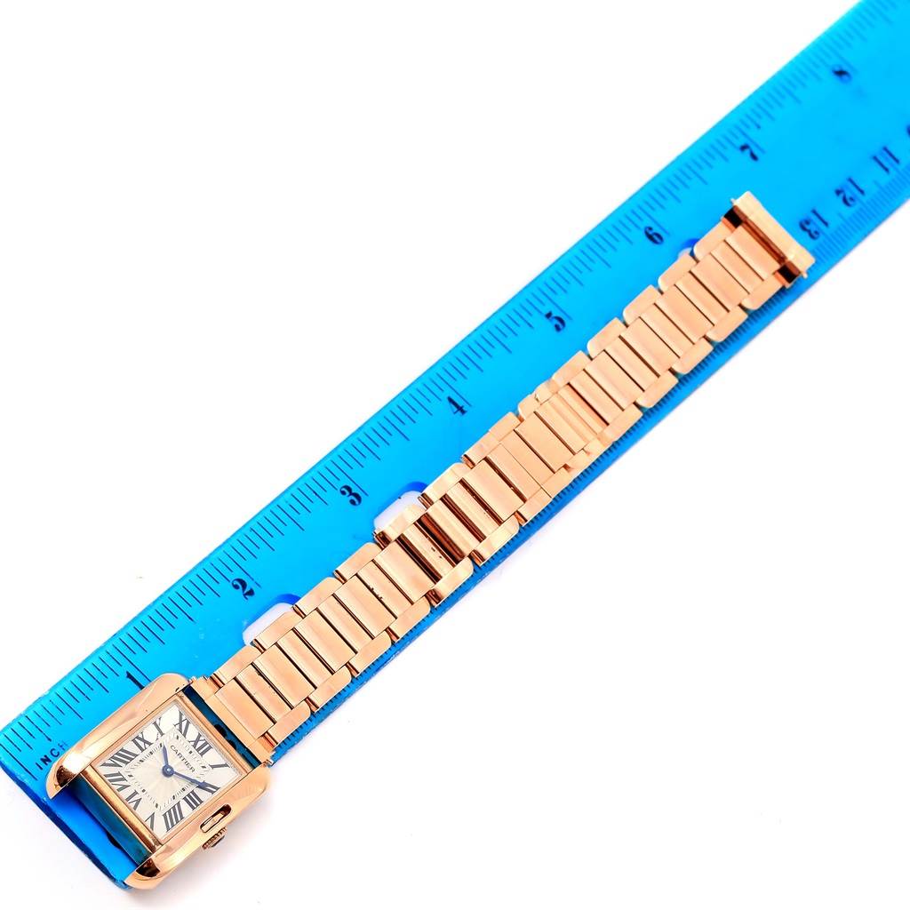 The image shows a Cartier Tank Anglaise W5310013 Women's Rose Gold Silver Dial W5310013 Women's Rose Gold Silver Dial watch laid flat with a ruler beside it.
