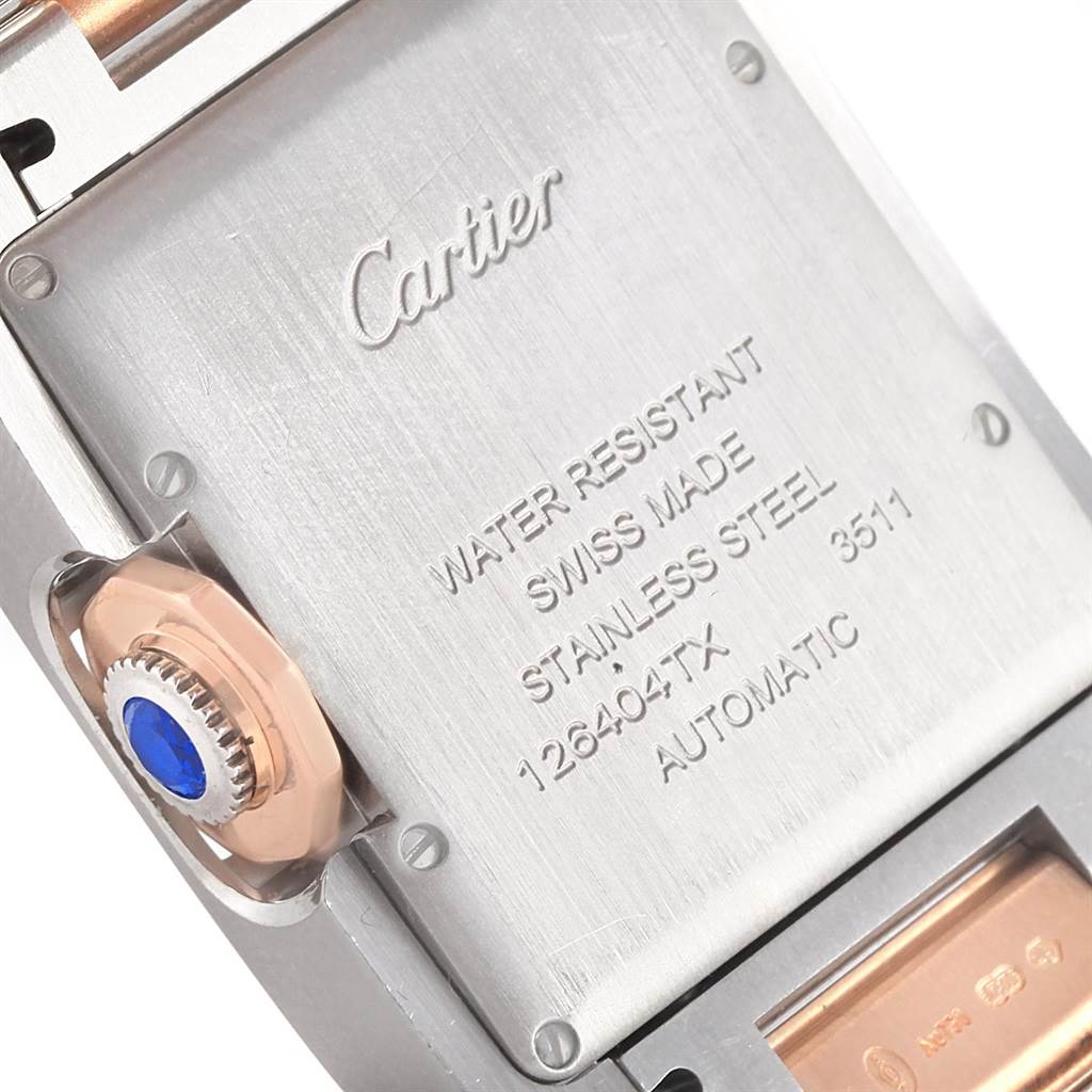 This image shows the back case and crown of a Cartier Tank Anglaise WT100034 Steel and Gold (two tone) Silver Dial WT100034 Steel and Gold (two tone) Silver Dial watch, highlighting its inscriptions and blue cabochon.