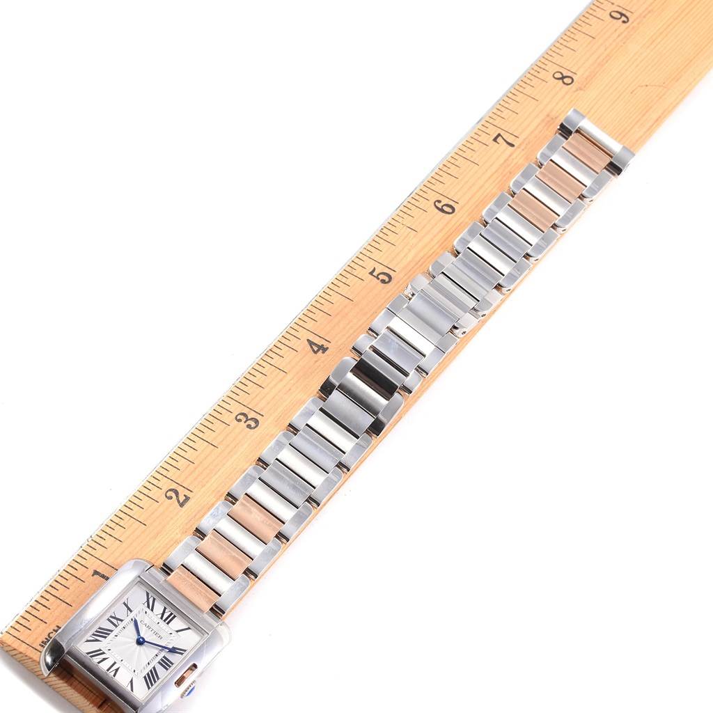 The image shows a Cartier Tank Anglaise WT100032 Women's Steel and Gold (two tone) Silver Dial WT100032 Women's Steel and Gold (two tone) Silver Dial watch laying flat on a ruler, displaying the face and full metal strap.