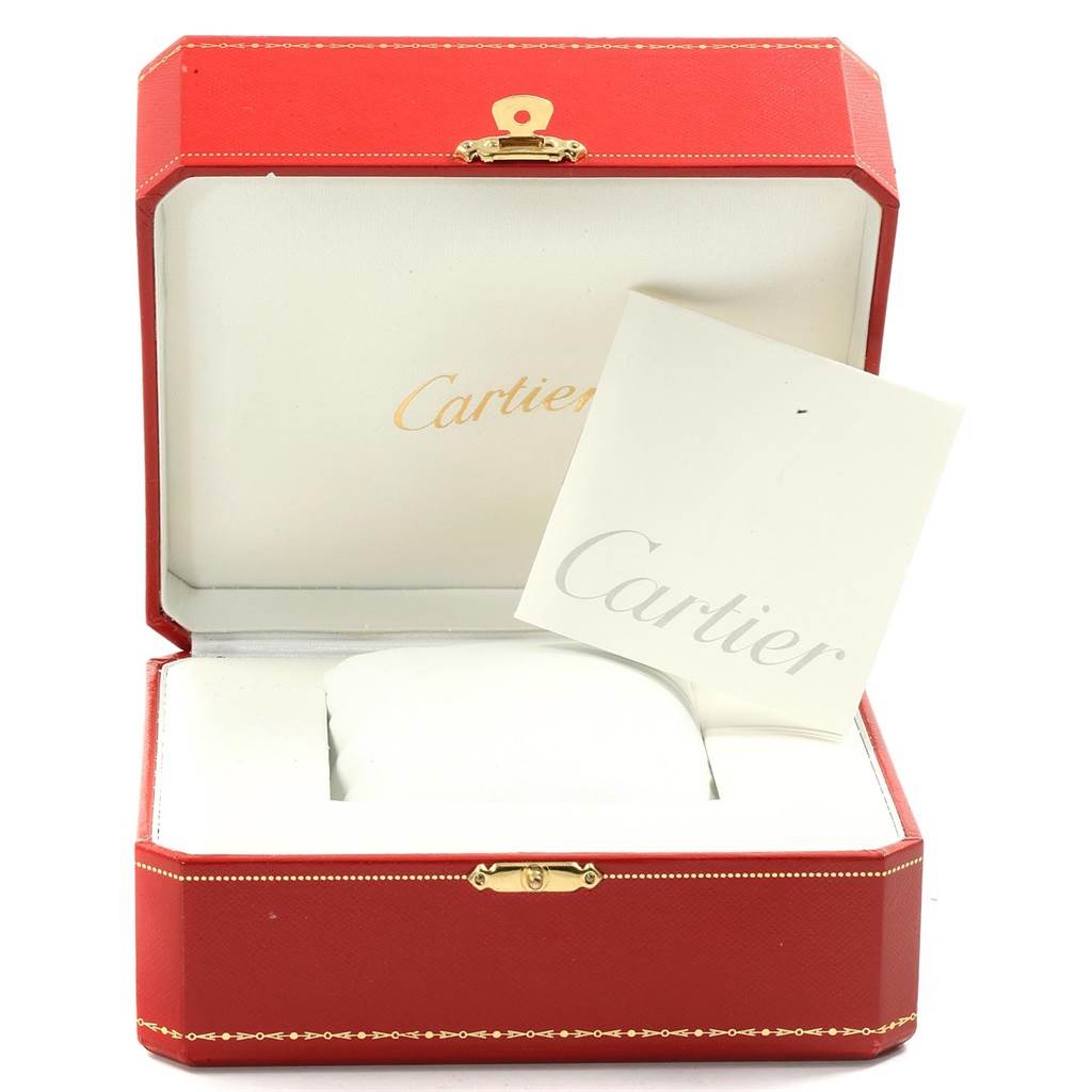 The image shows an open red Cartier box with the Tank Anglaise model's cushion and booklet inside.