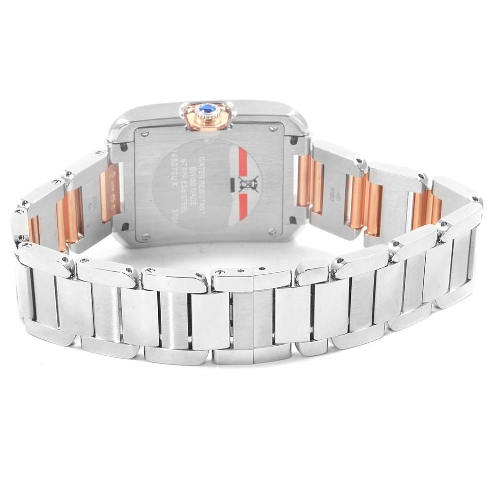 This image shows the back case and bracelet of a Cartier Tank Anglaise WT100032 Women's Steel and Gold (two tone) Silver Dial WT100032 Women's Steel and Gold (two tone) Silver Dial watch, including the crown with a blue gemstone.