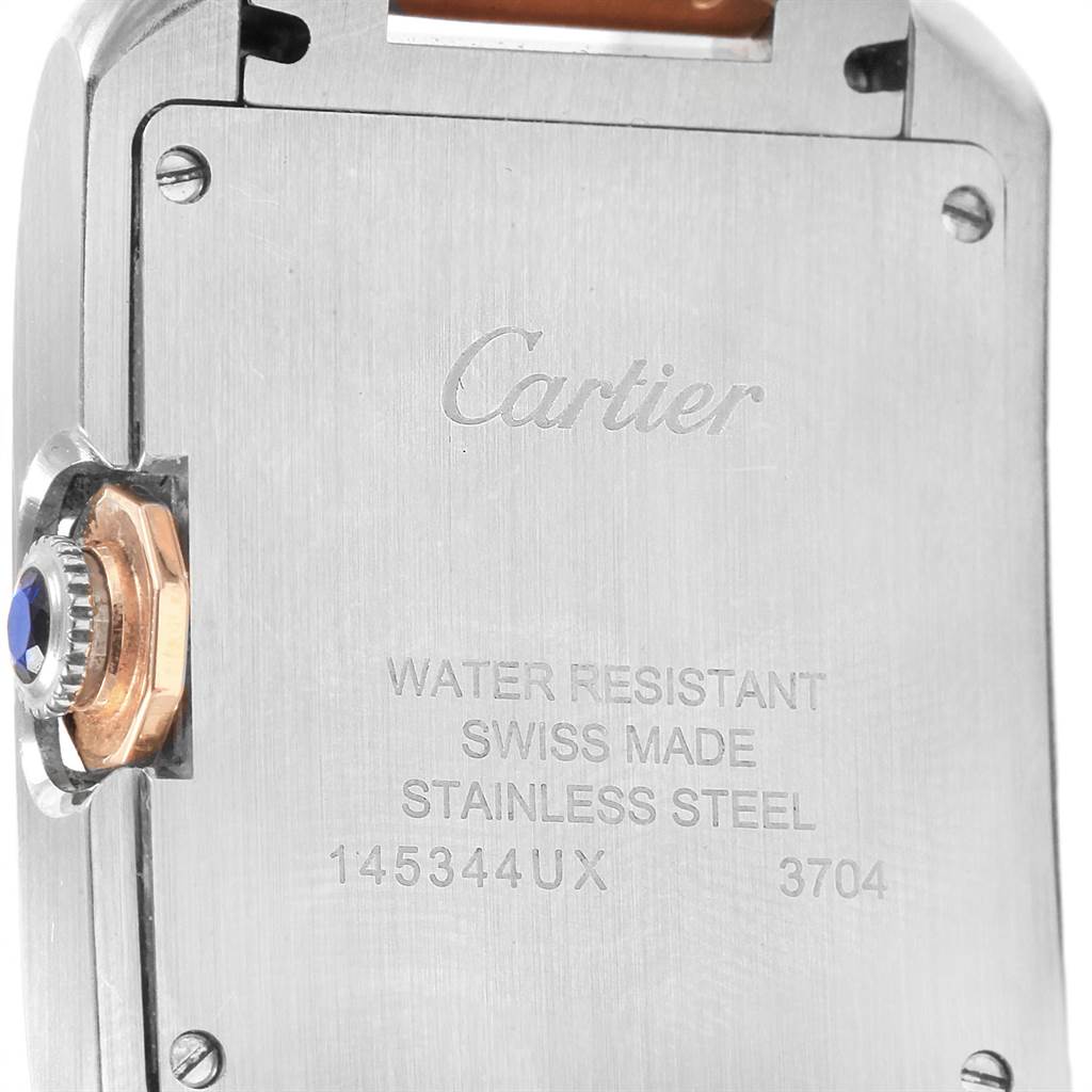 The image shows the back case and crown of the Cartier Tank Anglaise WT100032 Women's Steel and Gold (two tone) Silver Dial WT100032 Women's Steel and Gold (two tone) Silver Dial watch, highlighting the brand inscription and serial information.