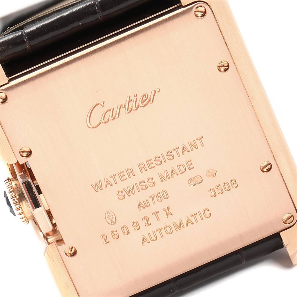 This image shows the back case of a Cartier Tank Anglaise W5310005 Women's Rose Gold Silver Dial W5310005 Women's Rose Gold Silver Dial watch, featuring engraved details and part of the black watch strap.