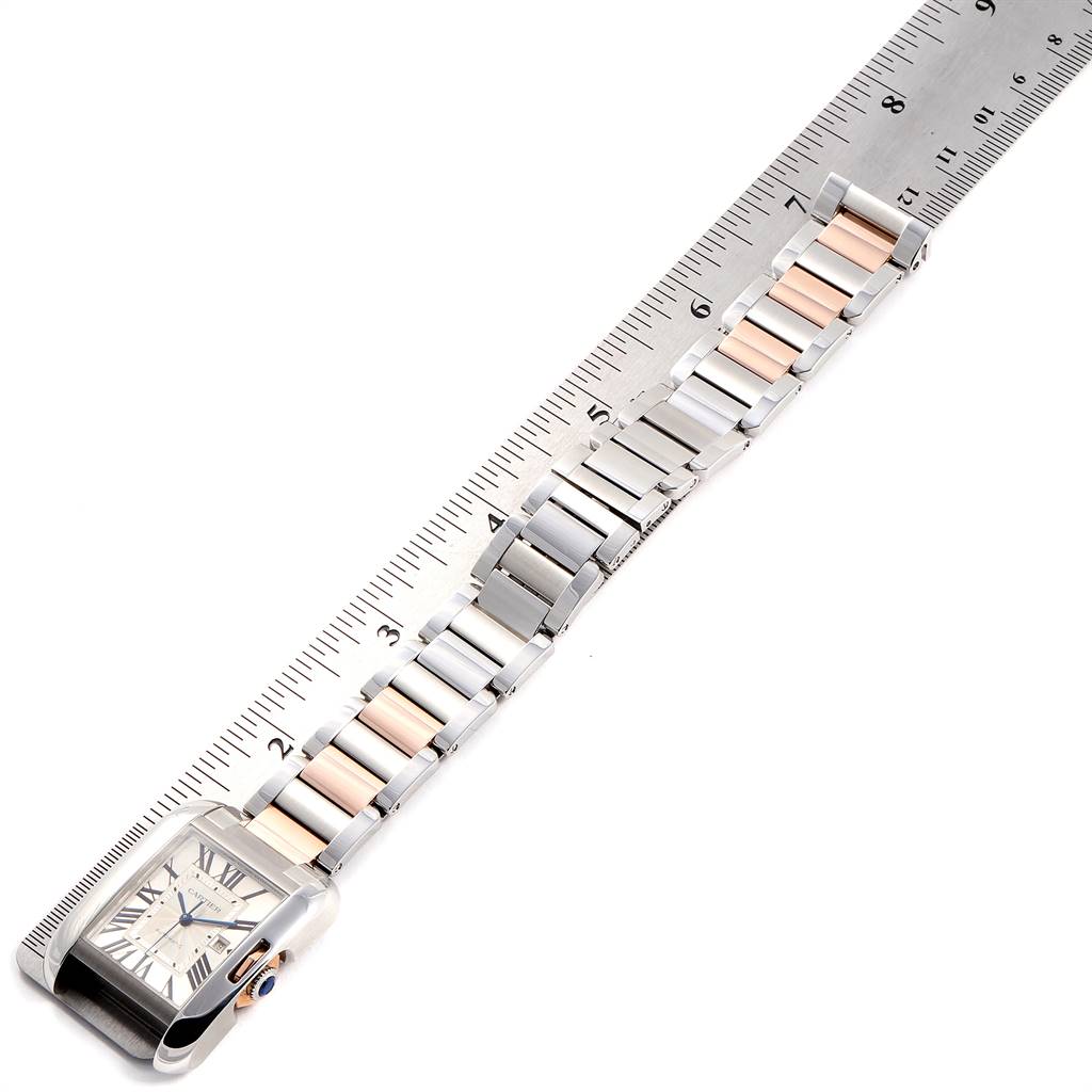 The image shows a Cartier Tank Anglaise W5310007 Women's Steel and Gold (two tone) Silver Dial W5310007 Women's Steel and Gold (two tone) Silver Dial watch at a top-down angle, highlighting the face and metal bracelet laid next to a ruler.