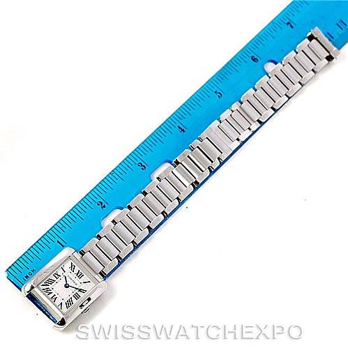 The image shows a top-down view of the Cartier Tank Anglaise W5310022 Women's Stainless Steel Silver Dial W5310022 Women's Stainless Steel Silver Dial watch alongside a blue ruler for measurement.