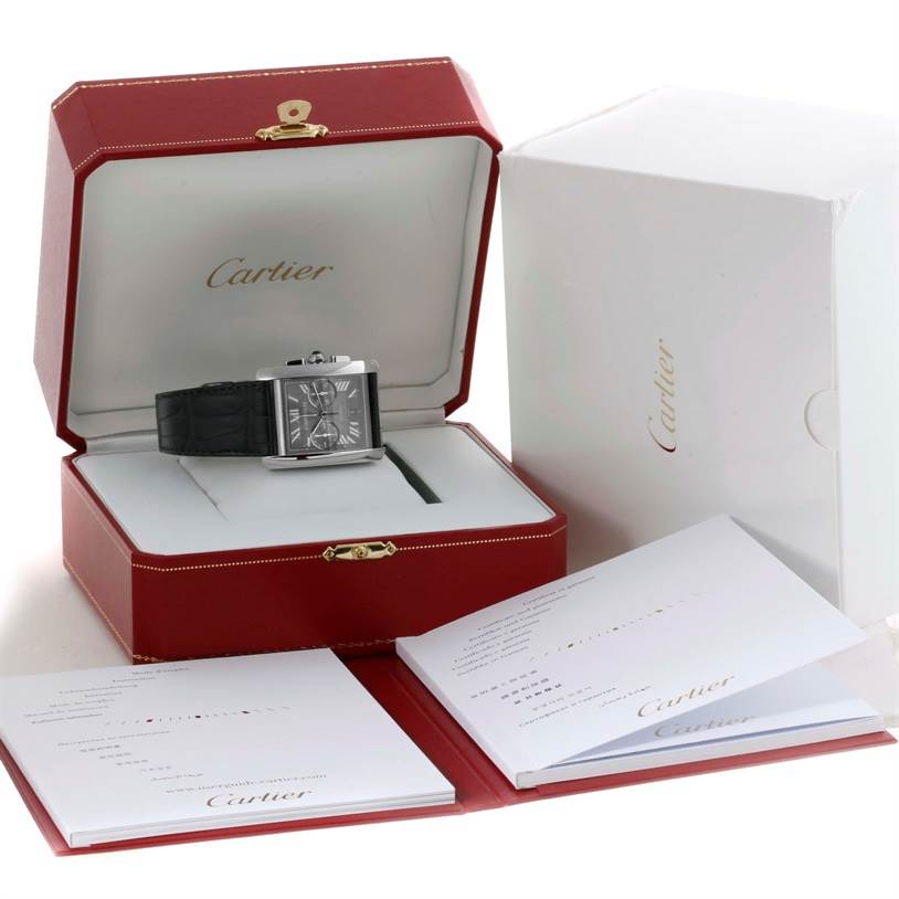 The Cartier Tank MC W5330008 Men's Stainless Steel Grey Dial W5330008 Men's Stainless Steel Grey Dial watch is displayed in an open red box, along with accompanying documentation and outer white packaging.