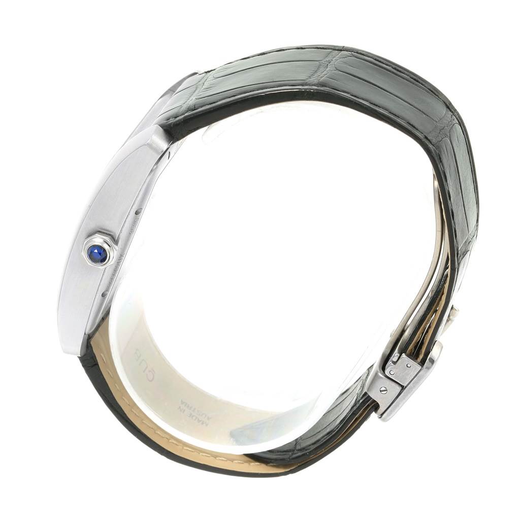 The image shows the side profile of a Cartier Tank MC W5330003 Men's Stainless Steel Silver Dial W5330003 Men's Stainless Steel Silver Dial watch, including the strap, buckle, and crown with a blue jewel.